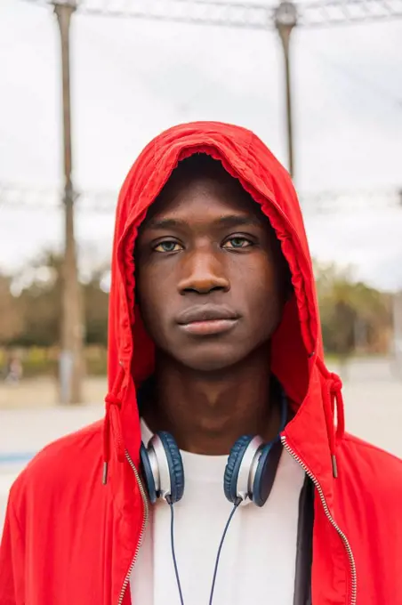 Portrait of a young black man wearing red hoodie