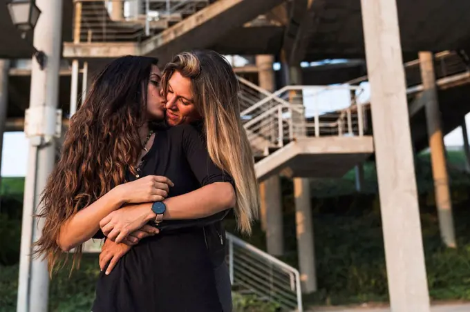 Lesbian couple kissing outdoors
