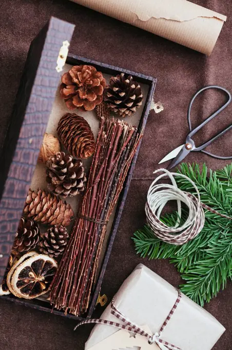 Utensils for wrapping Christmas presents on rustic leather