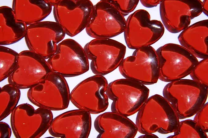 Red heart-shaped glass objects, close-up