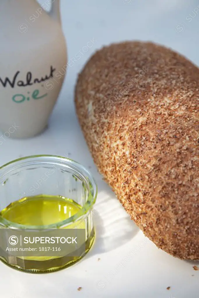 Walnut oil and a bread on a table