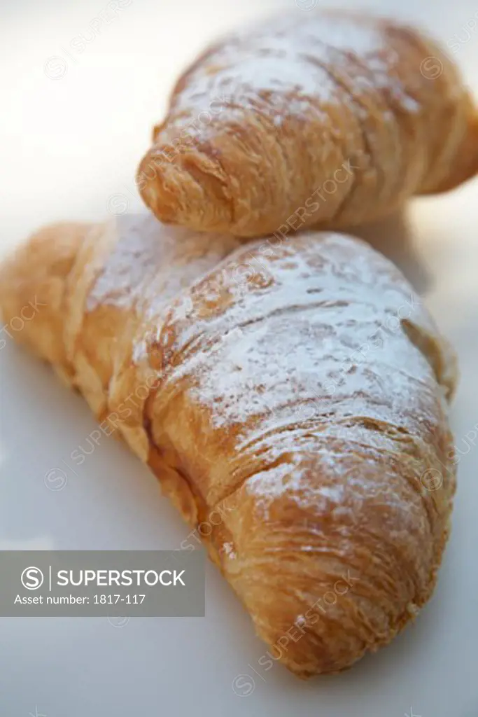 Two baked croissants on a table