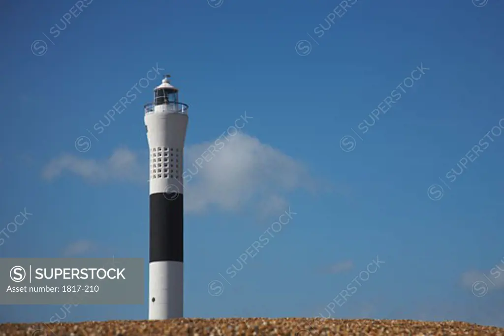 Black and white striped lighthouse on English coastline, England