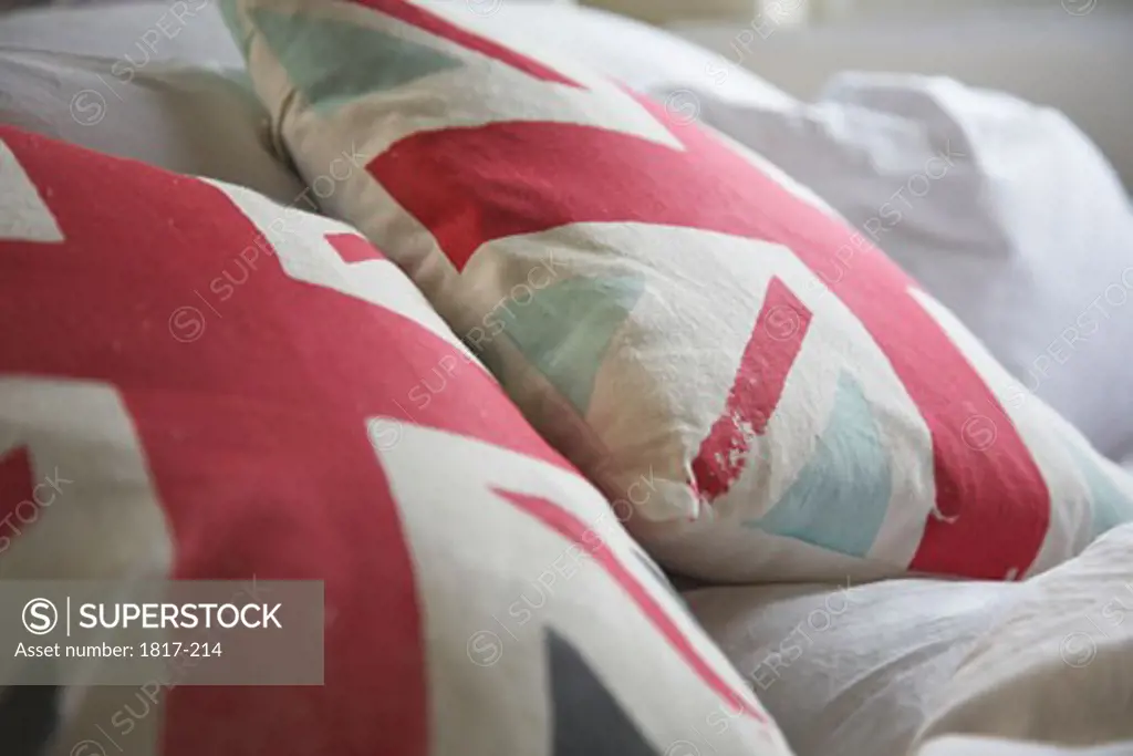A pair of Union Jack print pillow on a bed