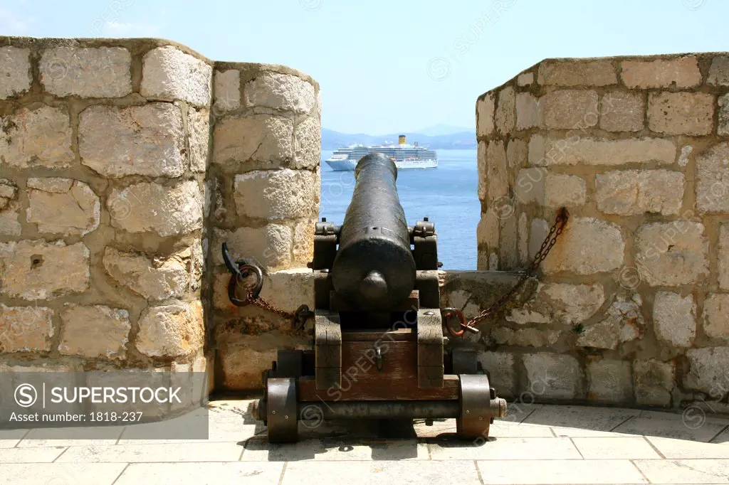 Cannon at a fort overlooking a ship in the sea, Dubrovnik, Dalmatia, Croatia
