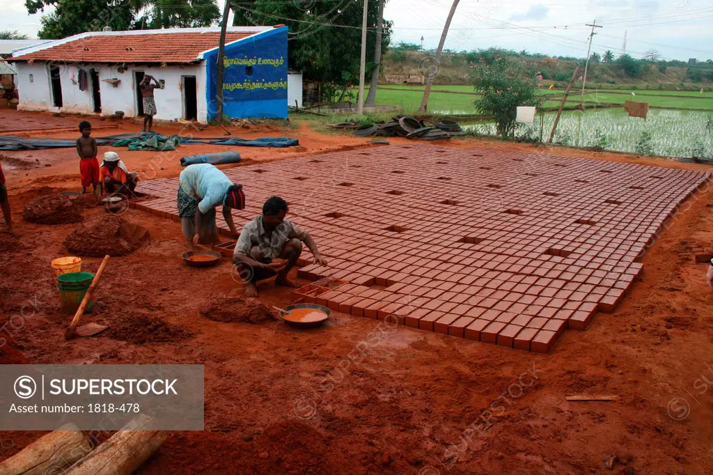 making mud bricks, India
