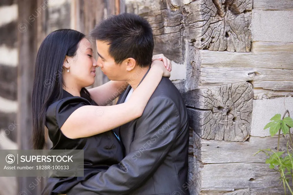 Couple Kissing by Log Cabin, Toronto, Ontario, Canada. 05/06/2012
