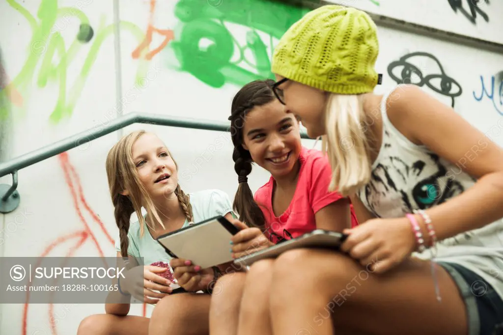 Girls Sitting on Steps with Tablet Computers, Mannheim, Baden-Wurttemberg, Germany. 08/31/2013