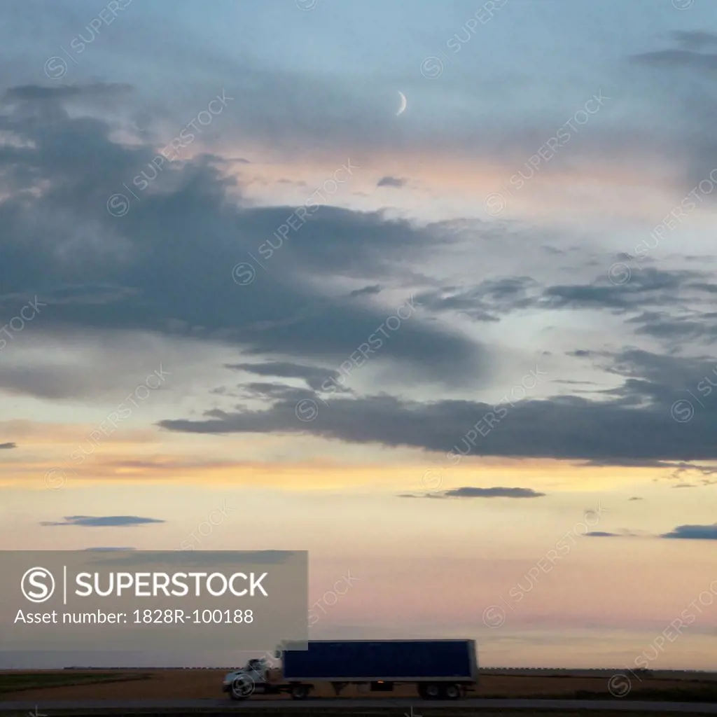 Transport truck at dusk on the Trans Canada Highway near Swift Current, Alberta, Canada. 09/08/2013