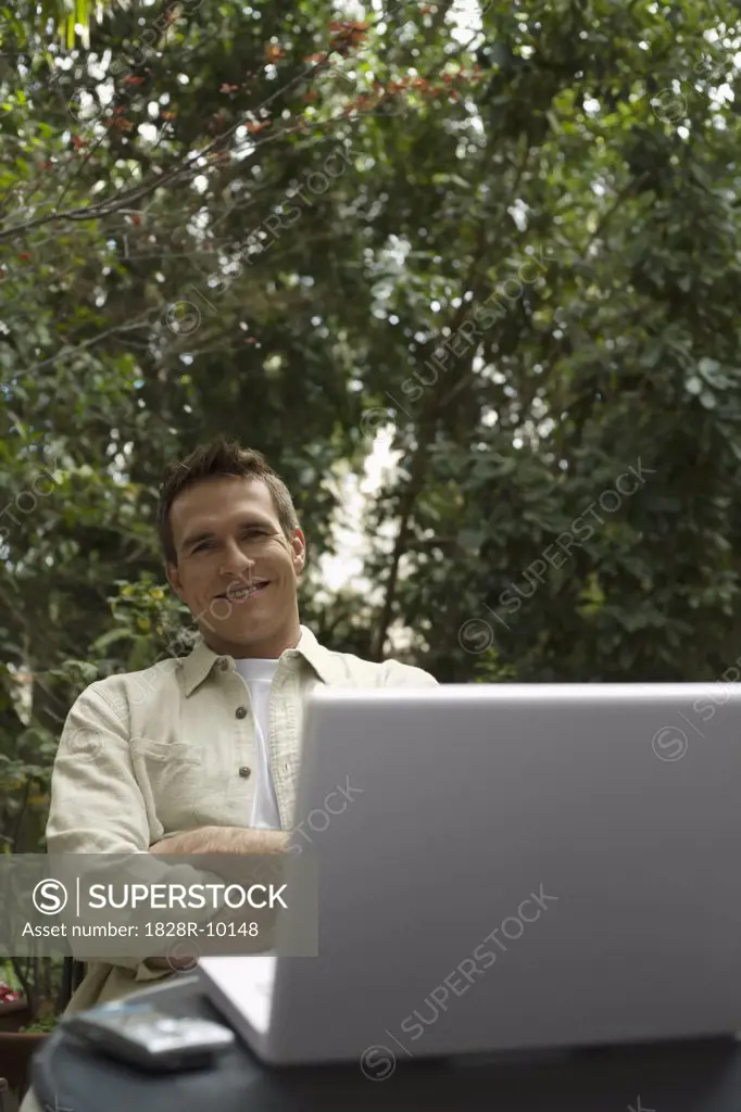 Man Sitting Outside With Laptop Computer   