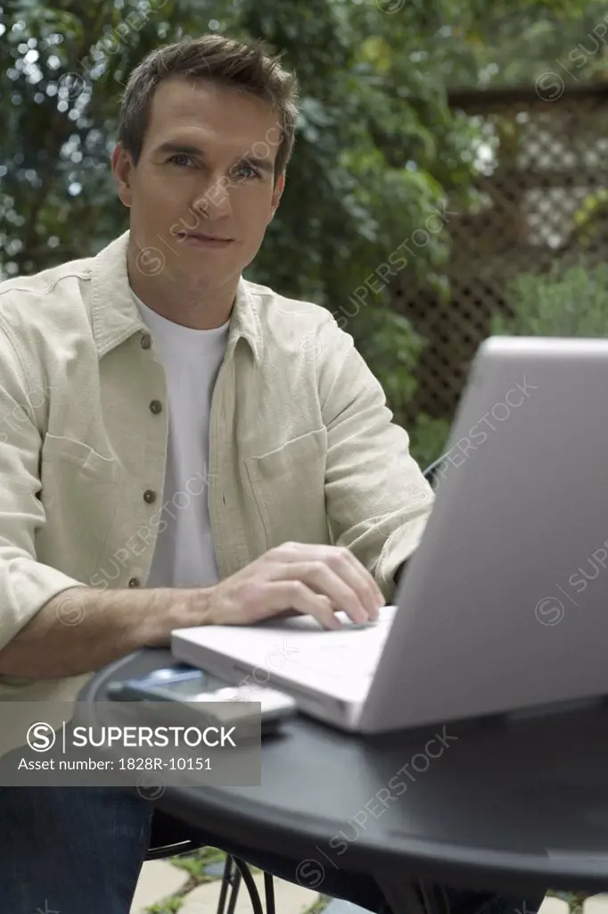 Man Sitting Outside With Laptop Computer   