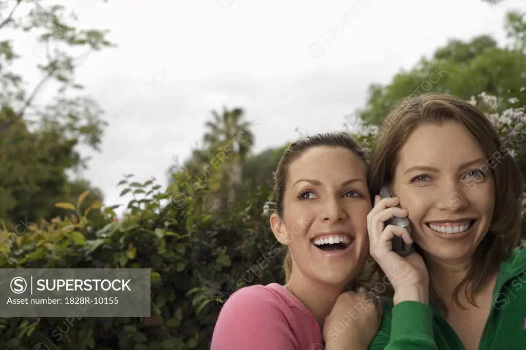 Women Listening To A Cell Phone   