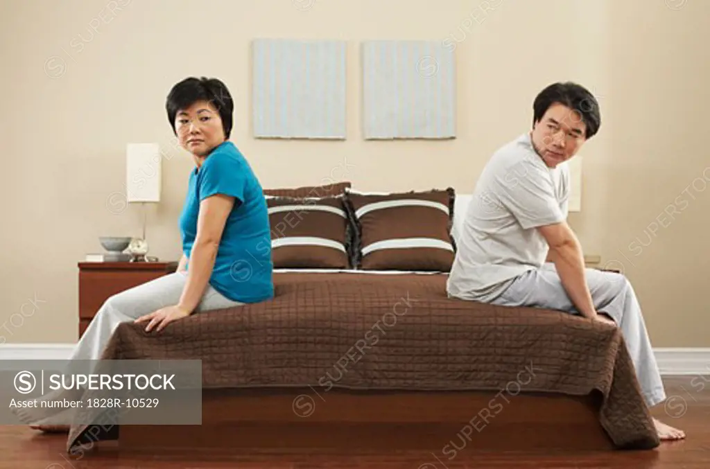 Upset Couple in Bedroom   