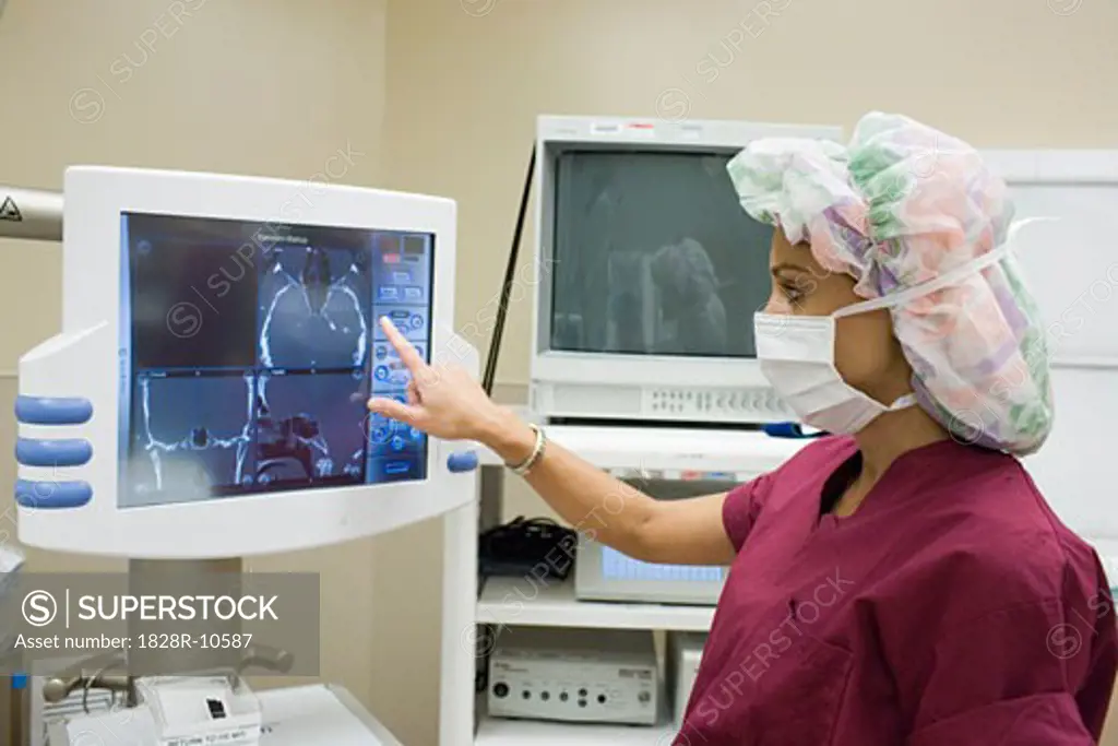 Doctor Looking at Monitor in Operating Room   