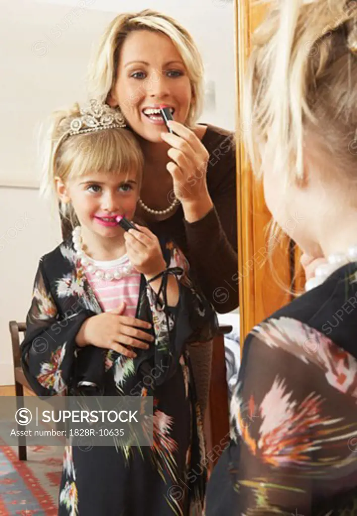 Mother and Daughter Applying Lipstick   