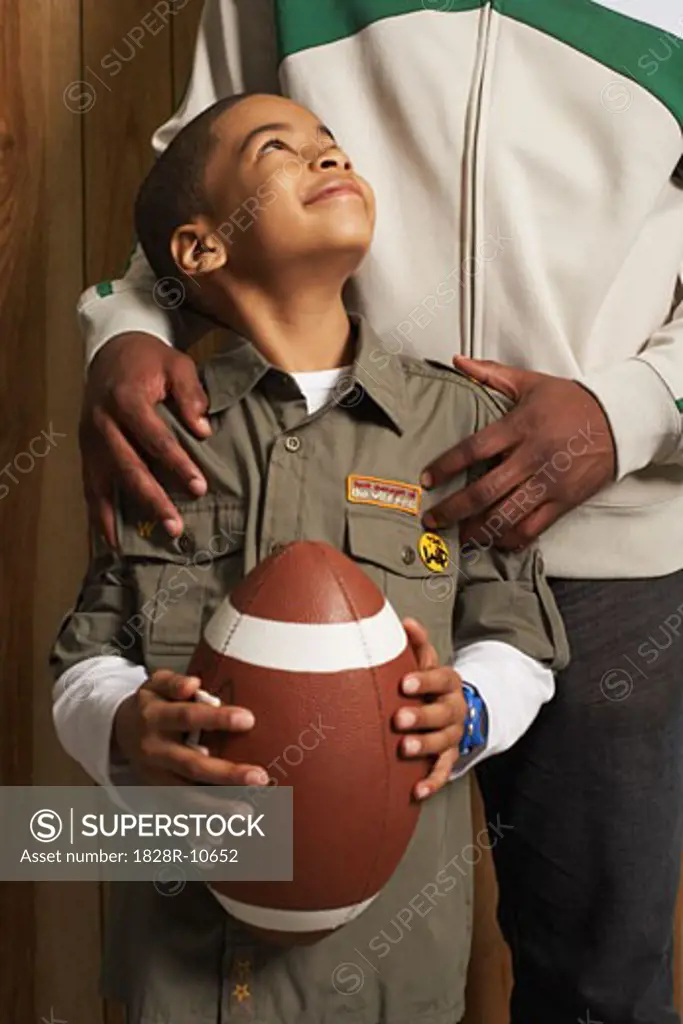 Child Holding a Football   