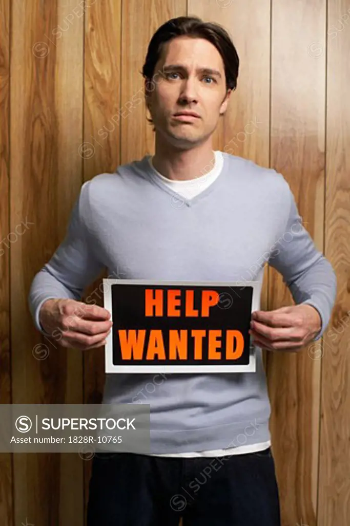 Man Holding Help Wanted Sign   
