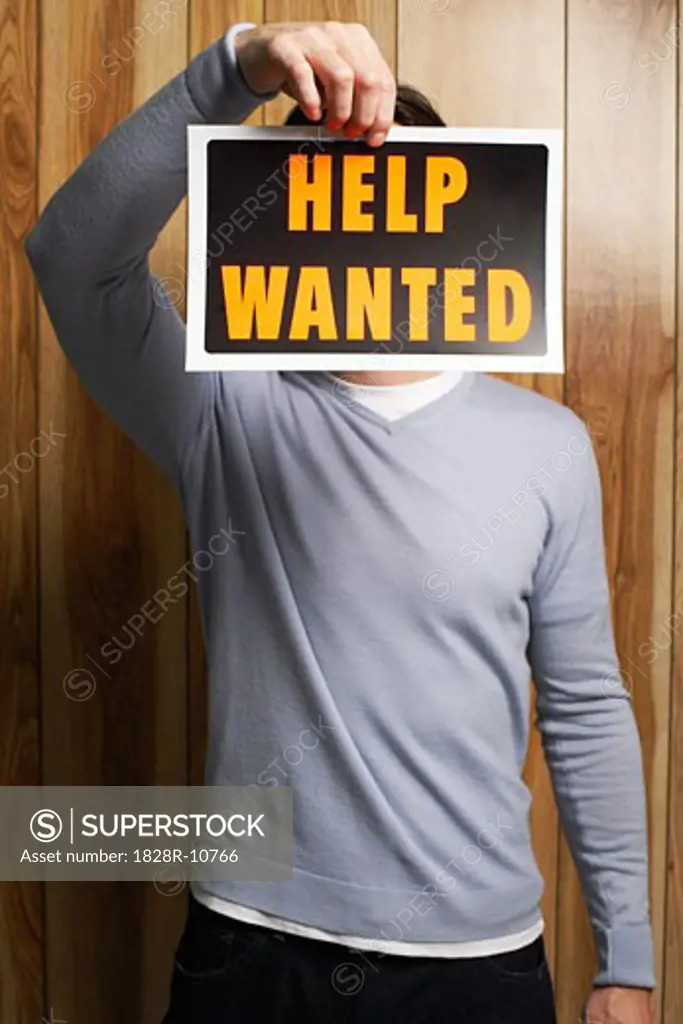 Man Holding Help Wanted Sign   