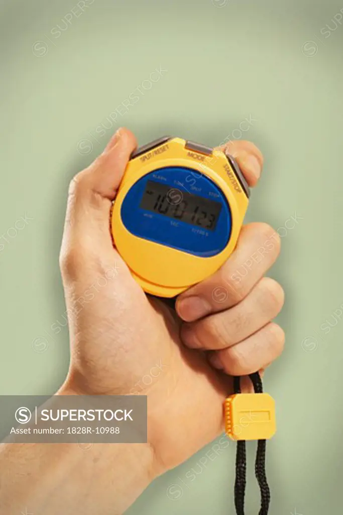 Person's Hand Holding Stopwatch   