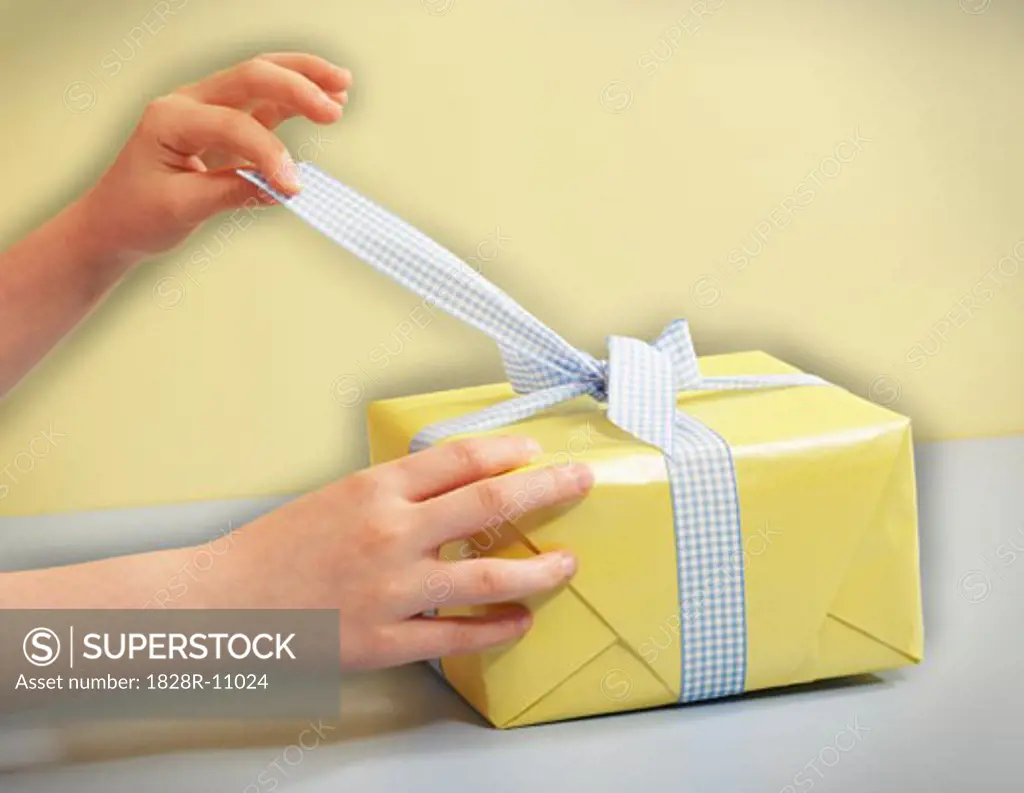 Child's Hands Opening Gift   