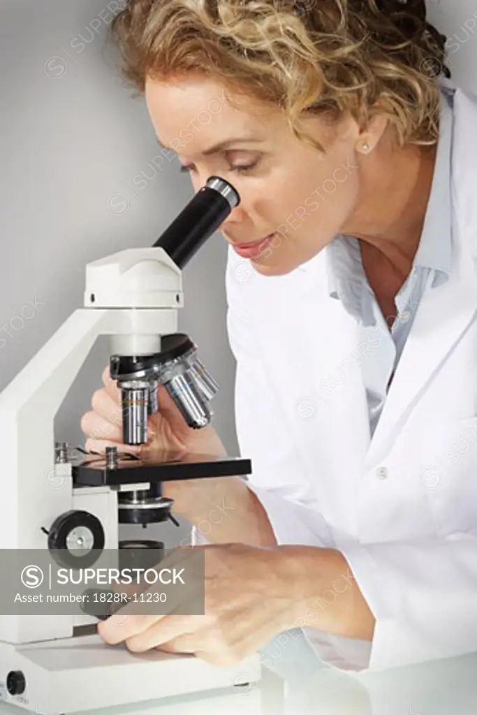 Doctor Looking Into Microscope   