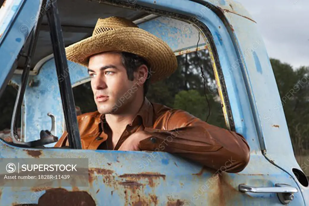 Man In Cowboy Hat and Rusty Truck   