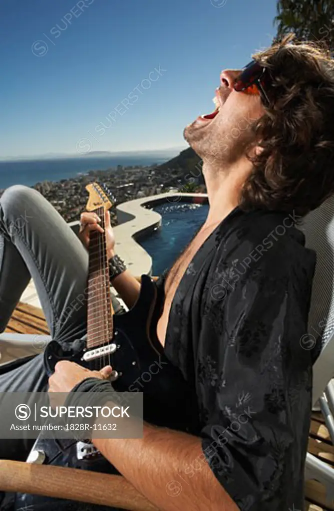Man Yelling and Playing Guitar   