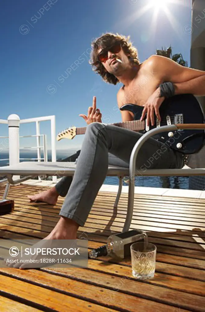 Man With Guitar Making Rude Hand Gesture   