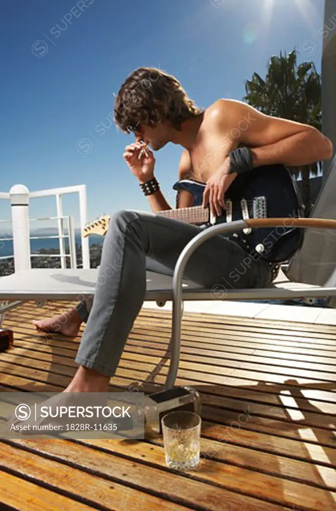 Man Holding Guitar, Smoking Cigarette   