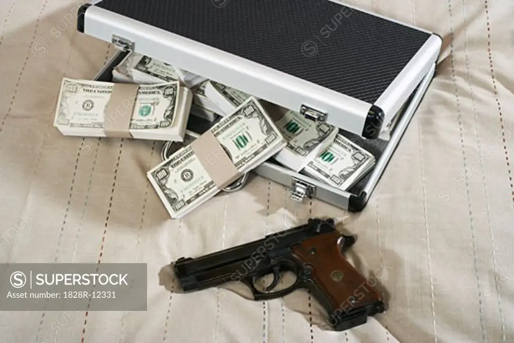 Gun and Briefcase Full of Money   