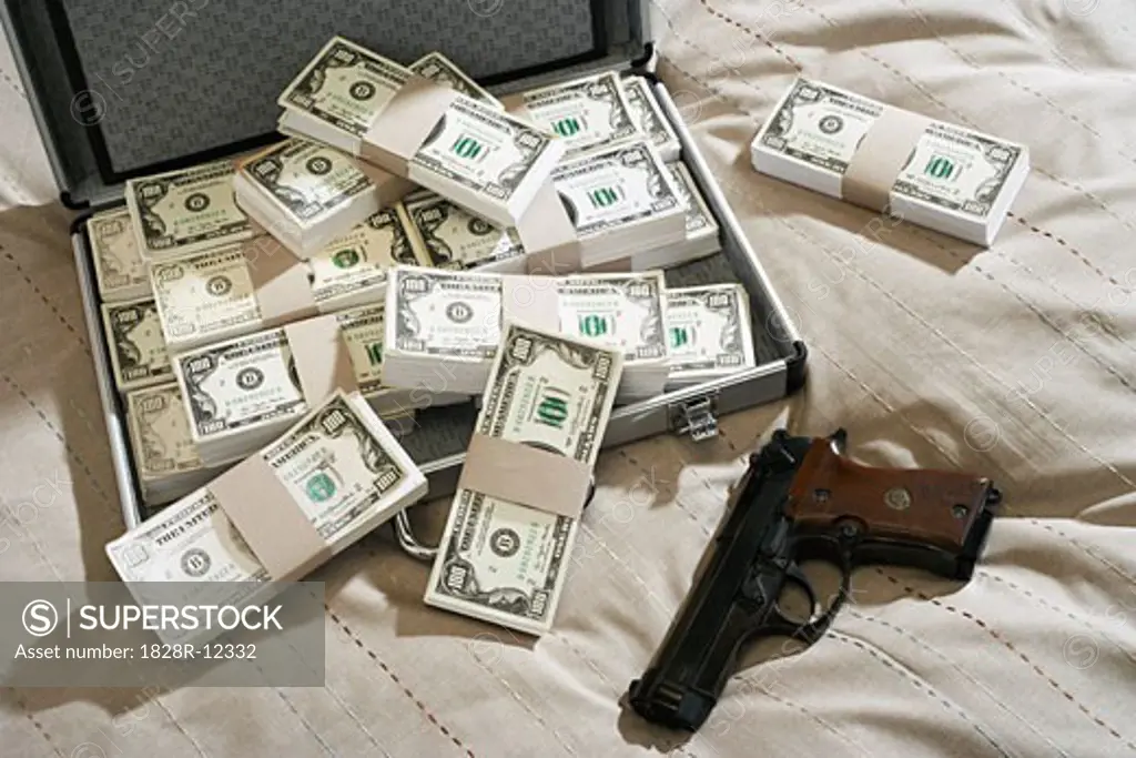 Gun and Briefcase Full of Money   