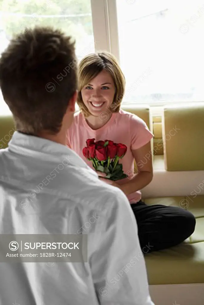 Man Giving Woman Bouquet of Roses   