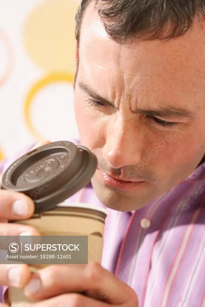 Man Looking in Coffee Cup   