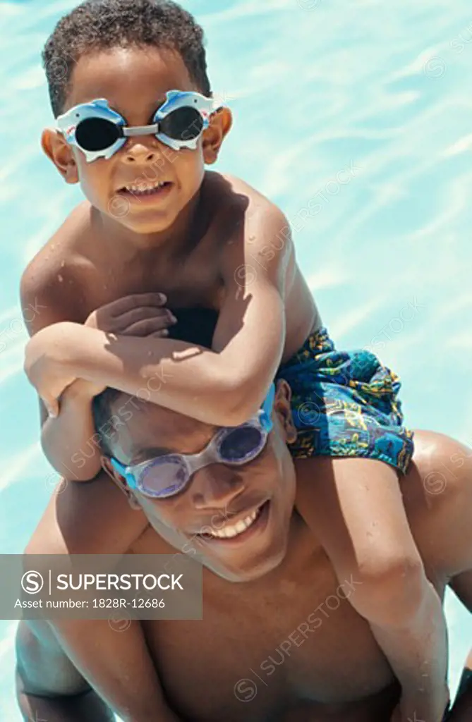 Portrait of Father and Son In Swimming Pool   