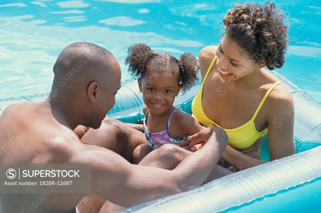 Family Playing in Swimming Pool   