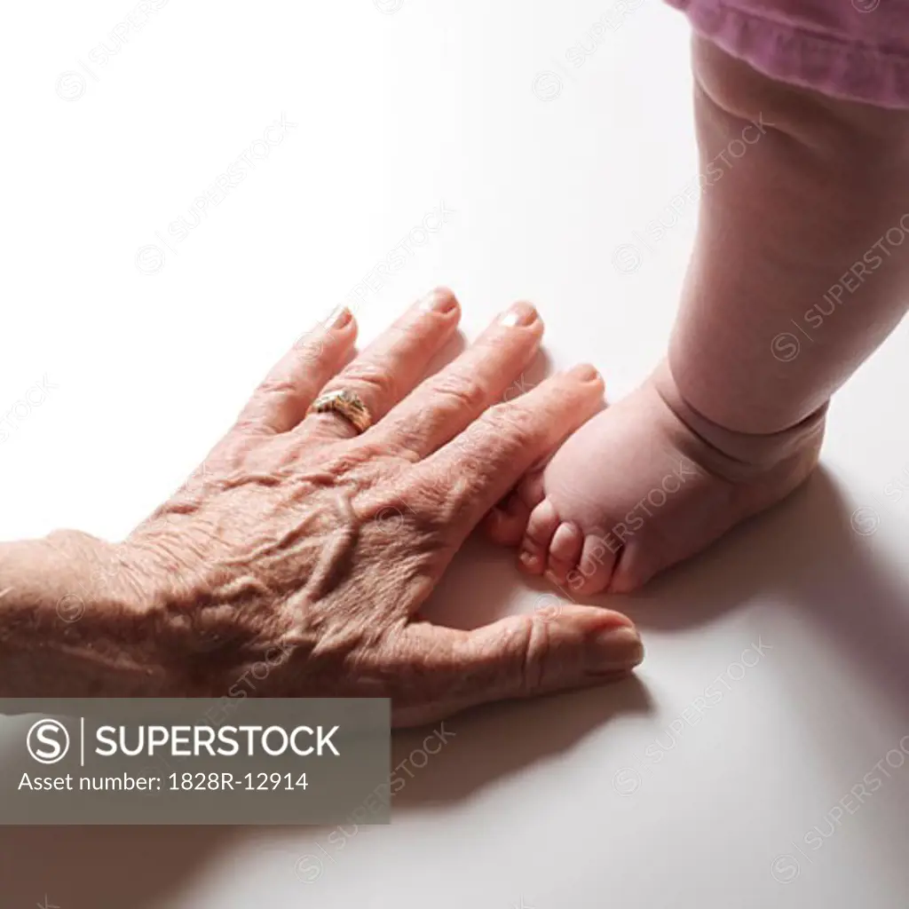 Woman's Hand by Baby's Foot   