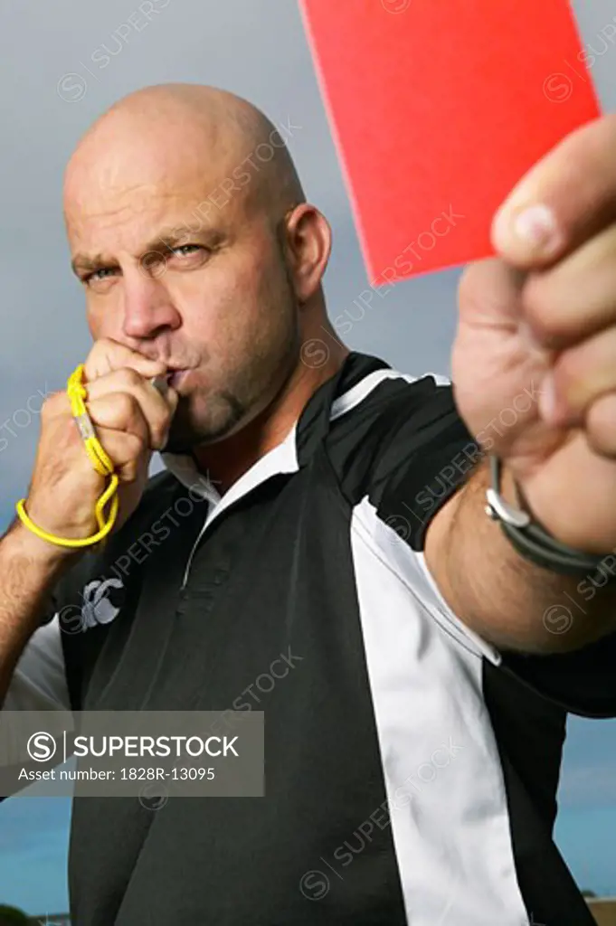 Referee Holding Red Card   