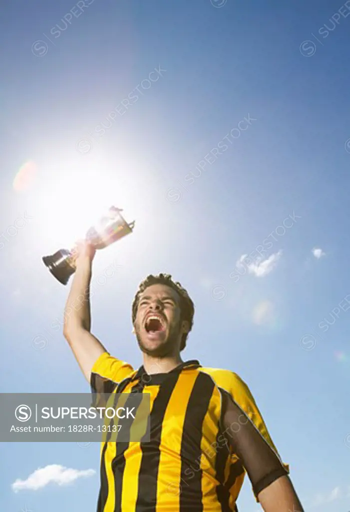 Portrait of Soccer Player Holding Trophy   