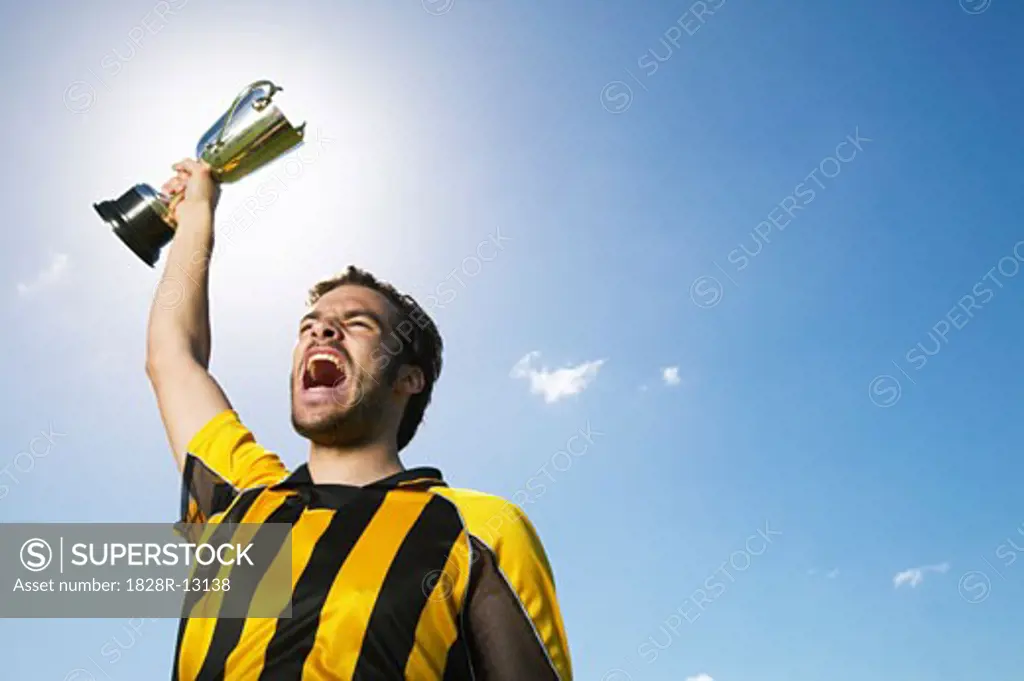 Portrait of Soccer Player Holding Trophy   