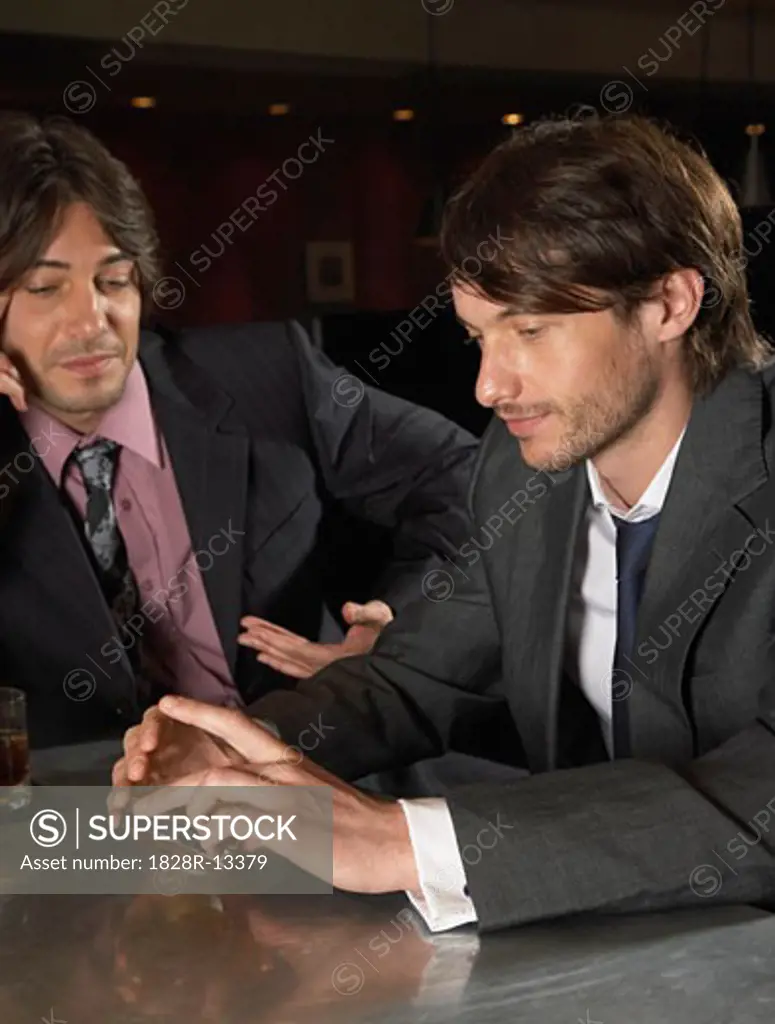 Businessmen Drinking at Bar   
