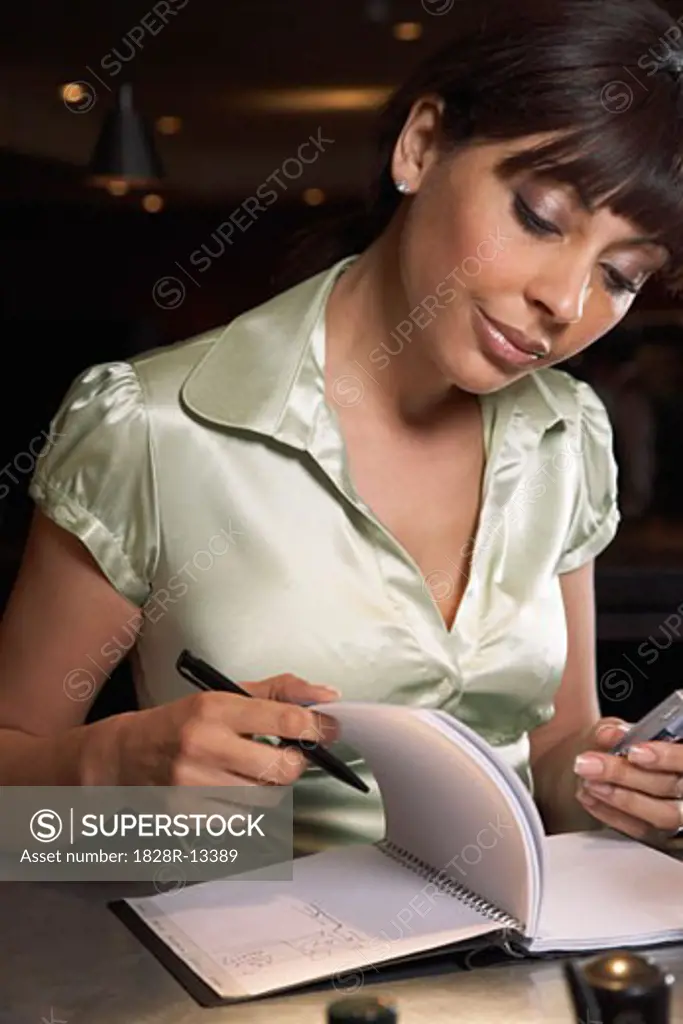 Woman Writing in Journal at Bar   