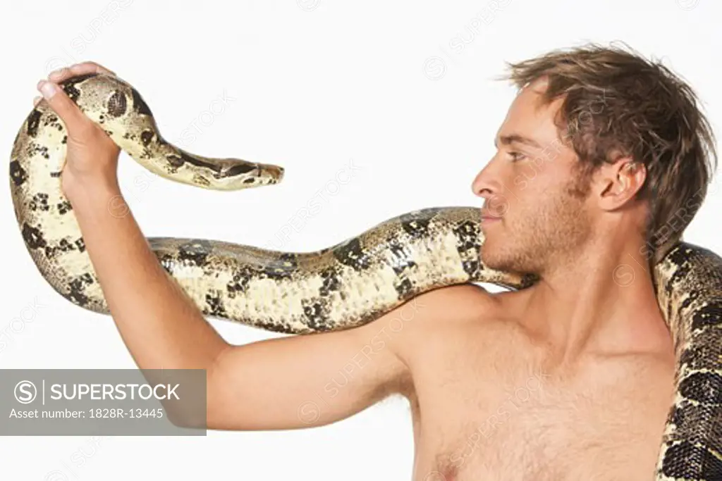 Close-up of Man and Snake Looking at Each Other   