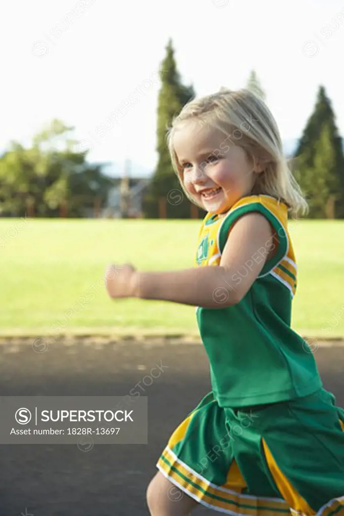 Girl Dressed as Cheerleader Running   