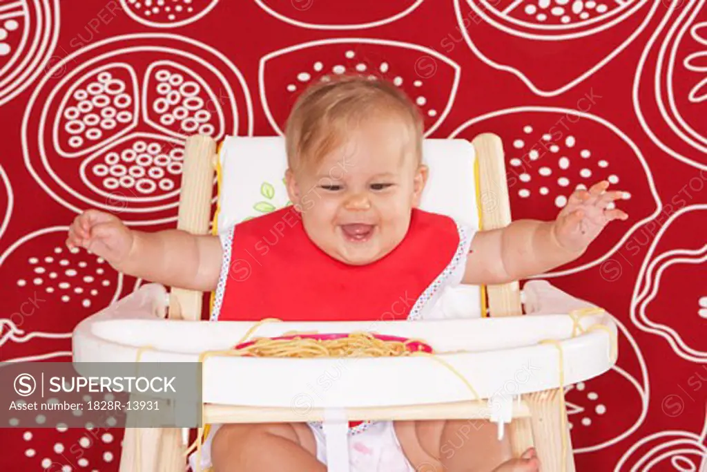 Baby with Spaghetti in High Chair   