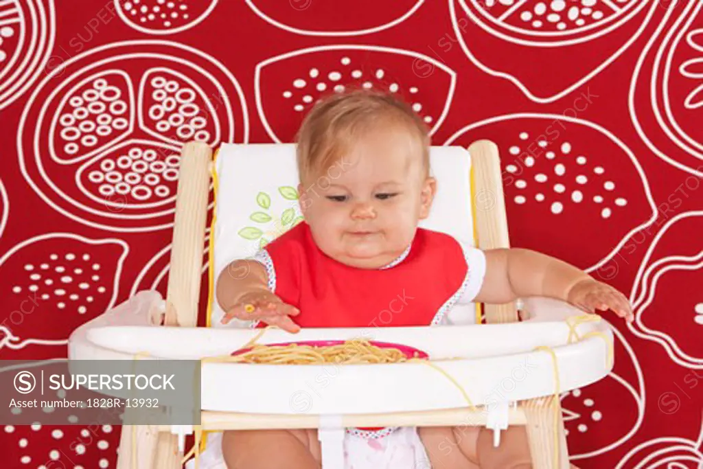 Baby with Spaghetti in High Chair   
