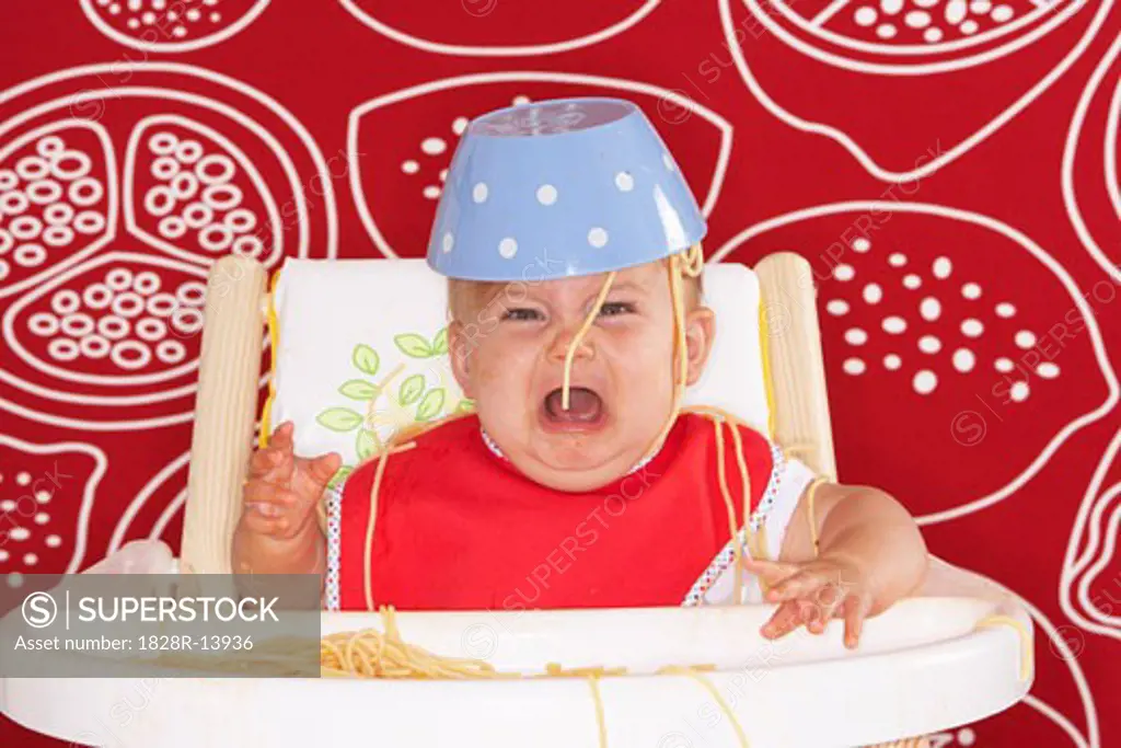 Baby in High Chair with Spaghetti Bowl on Head   