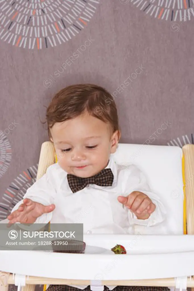 Baby in High Chair with Dessert   