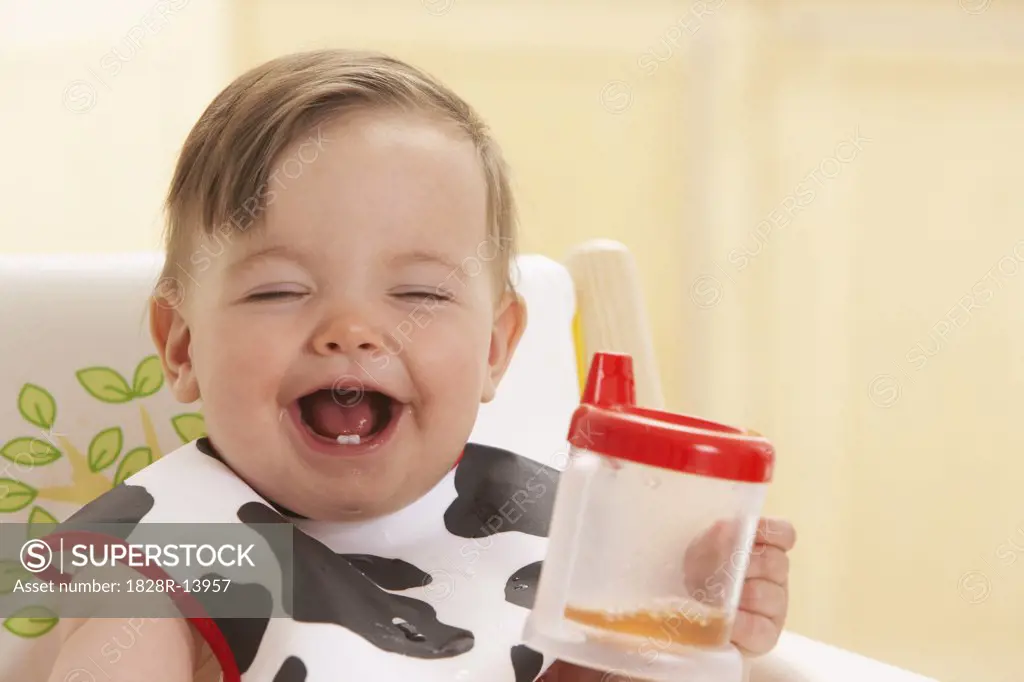 Child in High Chair with Juice   