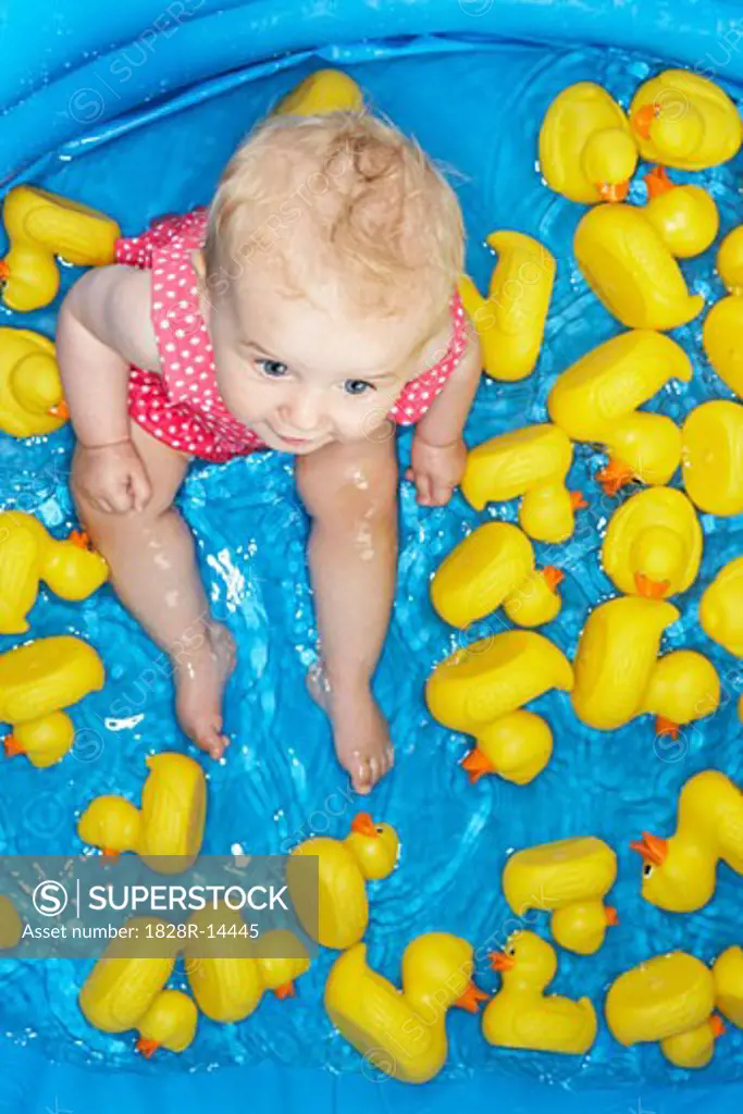 Baby Girl in Pool with Rubber Ducks   