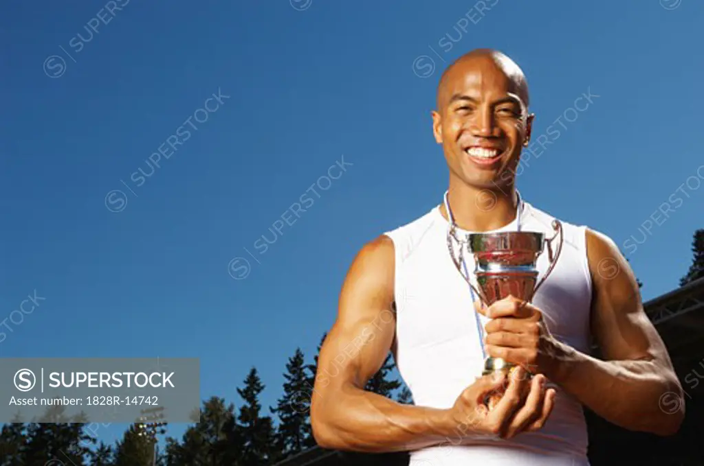 Athlete Holding Trophy   